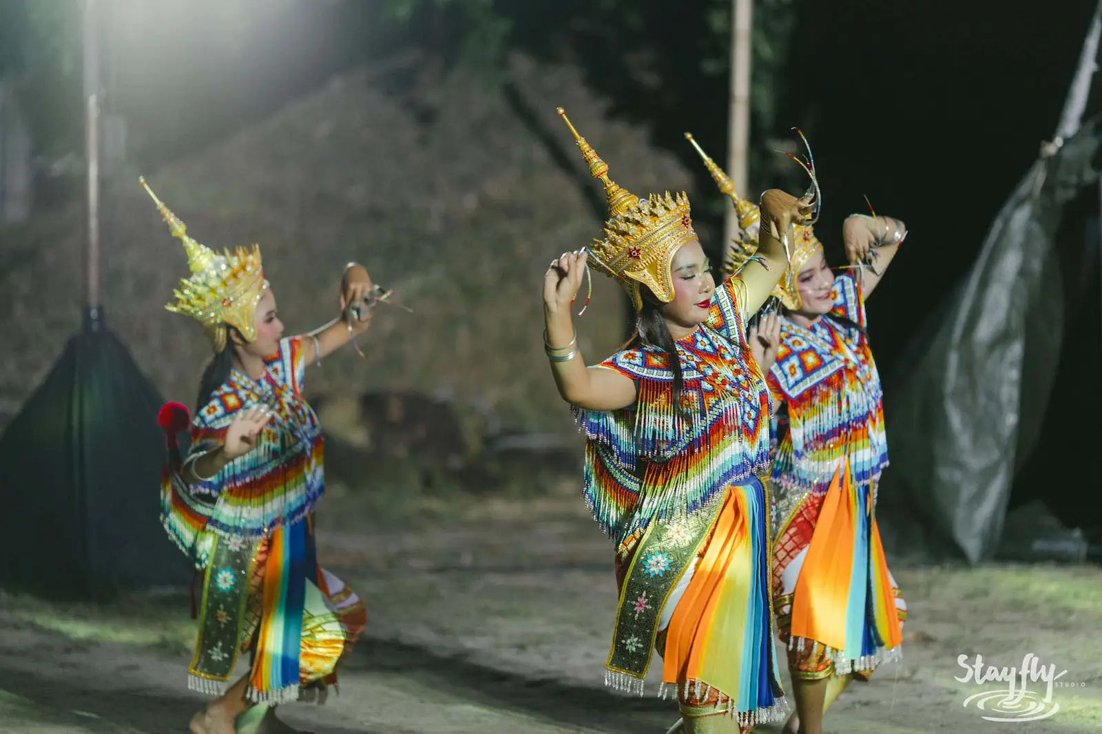 Traditional Thai dancers performing at night.
